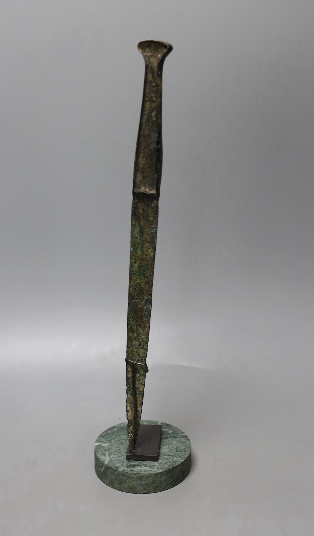 A Lurestan bronze dagger, on stand, 34.5 cms high.